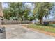 Expansive backyard featuring mature trees, a privacy fence, a shed, and a concrete patio for entertaining at 1053 Yarmouth St, Port Charlotte, FL 33952