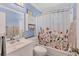 Bathroom featuring a floral shower curtain, bright blue walls, and vanity at 1053 Yarmouth St, Port Charlotte, FL 33952