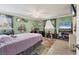 Bedroom boasts natural light, ceiling fan, and colorful accent rug at 1053 Yarmouth St, Port Charlotte, FL 33952