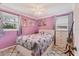 Comfortable bedroom with natural light, light pink walls, and a cozy quilt on the bed at 1053 Yarmouth St, Port Charlotte, FL 33952