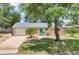 Charming single Gathering home featuring a well maintained lawn, landscaping, and a bright, welcoming blue front door at 1053 Yarmouth St, Port Charlotte, FL 33952