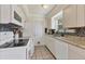 Efficient white kitchen featuring tile backsplash, stainless steel sink, white appliances and tile flooring at 1053 Yarmouth St, Port Charlotte, FL 33952