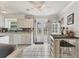 Bright kitchen featuring white cabinets, matching appliances, and double doors to the backyard at 1053 Yarmouth St, Port Charlotte, FL 33952