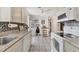 Bright kitchen with white cabinetry, neutral countertops, a pantry, and tile flooring at 1053 Yarmouth St, Port Charlotte, FL 33952
