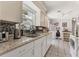 Updated kitchen featuring granite counters, stainless steel appliances, and tile flooring, and a sunlit window at 1053 Yarmouth St, Port Charlotte, FL 33952