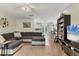 Bright and airy living room leading into the kitchen, showcasing hardwood floors, neutral walls, and a ceiling fan at 1053 Yarmouth St, Port Charlotte, FL 33952