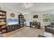Cozy living room featuring a ceiling fan, neutral paint, a front door, and natural light from the large window at 1053 Yarmouth St, Port Charlotte, FL 33952