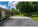 Backyard showcases mature trees, green spaces, and concrete patio, perfect for entertaining or relaxing outdoors at 10810 Wheeler Pl, Punta Gorda, FL 33950