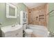 Bathroom featuring a large soaking tub, tiled walls, and traditional fixtures at 10810 Wheeler Pl, Punta Gorda, FL 33950