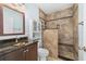 Updated bathroom with modern vanity, vessel sink, tiled shower, and built-in storage at 10810 Wheeler Pl, Punta Gorda, FL 33950