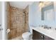 Tiled bathroom with a walk-in shower, modern fixtures, and sink vanity at 10810 Wheeler Pl, Punta Gorda, FL 33950