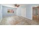 Bright bedroom featuring tile floors, ceiling fan and natural light with a closet at 10810 Wheeler Pl, Punta Gorda, FL 33950