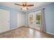 Inviting bedroom featuring tile floors, ceiling fan, and a view of the pool through sliding doors at 10810 Wheeler Pl, Punta Gorda, FL 33950