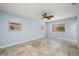 Bright bedroom with tile flooring, a ceiling fan, and multiple windows at 10810 Wheeler Pl, Punta Gorda, FL 33950