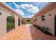 Spacious tiled courtyard featuring arched openings and views of the surrounding property at 10810 Wheeler Pl, Punta Gorda, FL 33950