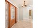 Bright foyer with decorative front door, tiled floors, and modern light fixture at 10810 Wheeler Pl, Punta Gorda, FL 33950