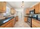 Bright kitchen showcasing wood cabinets, stainless steel appliances, granite counters, and tile flooring at 10810 Wheeler Pl, Punta Gorda, FL 33950