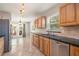 Charming kitchen featuring wood cabinets, stainless steel appliances, and black granite countertops at 10810 Wheeler Pl, Punta Gorda, FL 33950