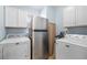 Practical laundry room with large appliances, including a washer, dryer, and stainless steel refrigerator at 10810 Wheeler Pl, Punta Gorda, FL 33950