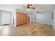 Open-concept living room features tile floors, two ceiling fans, and ample cabinet storage at 10810 Wheeler Pl, Punta Gorda, FL 33950