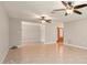 Open living room with tile flooring, neutral paint, and multiple ceiling fans at 10810 Wheeler Pl, Punta Gorda, FL 33950