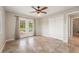 Bright living room featuring tile flooring, ceiling fan, and french doors to the pool at 10810 Wheeler Pl, Punta Gorda, FL 33950