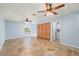 Spacious living room boasts tiled floors, ceiling fans, and direct access to the laundry room at 10810 Wheeler Pl, Punta Gorda, FL 33950