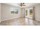 Bright living room featuring tile flooring, ceiling fan, and glass doors to the backyard at 10810 Wheeler Pl, Punta Gorda, FL 33950