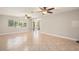 Large living room with tile floors, a large window, and sliding glass doors to the backyard at 10810 Wheeler Pl, Punta Gorda, FL 33950