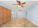 Open-concept living room features tile floors, two ceiling fans, and ample cabinet storage at 10810 Wheeler Pl, Punta Gorda, FL 33950