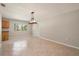 Open living room with a window offering natural light, and neutral wall paint over tile flooring at 10810 Wheeler Pl, Punta Gorda, FL 33950