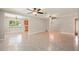 Spacious open-concept living room with tile flooring and ample natural light at 10810 Wheeler Pl, Punta Gorda, FL 33950