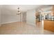 Open-concept living room and kitchen area with modern lighting and tile flooring at 10810 Wheeler Pl, Punta Gorda, FL 33950