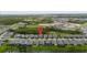 An aerial view of the home and neighborhood, highlighting its location near a lake and green spaces at 11105 Balfour E St, Venice, FL 34293