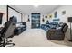 Entertainment room features a black reclining sofa, projector screen, and mood lighting at 11105 Balfour E St, Venice, FL 34293
