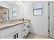 Bright bathroom featuring a double sink vanity with granite countertop, enhanced by modern fixtures at 11105 Balfour E St, Venice, FL 34293