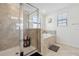 Well-appointed bathroom with a glass-enclosed shower and soaking tub, complemented by neutral tile at 11105 Balfour E St, Venice, FL 34293