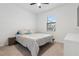 This bedroom is filled with natural light and offers neutral carpet and a ceiling fan at 11105 Balfour E St, Venice, FL 34293