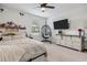 Bright bedroom featuring a ceiling fan, and whimsical hanging chair against neutral carpet at 11105 Balfour E St, Venice, FL 34293