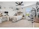 Bright bedroom featuring a ceiling fan, and whimsical hanging chair against neutral carpet at 11105 Balfour E St, Venice, FL 34293