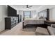 Spacious bedroom featuring a ceiling fan, and elegant dark wood furniture set against neutral carpet at 11105 Balfour E St, Venice, FL 34293