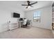 Bedroom features modern ceiling fan, a desk with dual monitors, and ample natural light at 11105 Balfour E St, Venice, FL 34293