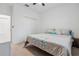 Bright bedroom features neutral carpet, ceiling fan and closet with bi-fold doors at 11105 Balfour E St, Venice, FL 34293