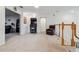 Open bonus room with arcade game, leather recliner, and views of the downstairs area at 11105 Balfour E St, Venice, FL 34293