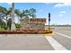 Tortuga Wellen Park entrance featuring stacked stone wall, lush landscaping, and clear signage at 11105 Balfour E St, Venice, FL 34293