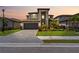 Stunning two-story home featuring a well-manicured lawn and gray brick driveway leading to a spacious two-car garage at 11105 Balfour E St, Venice, FL 34293