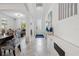 Open-concept foyer and dining area featuring tile flooring, elegant decor, and abundant natural light at 11105 Balfour E St, Venice, FL 34293