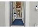 Inviting home foyer with high ceilings, neutral decor, a blue rug, and an open view to the dining and living areas at 11105 Balfour E St, Venice, FL 34293