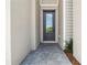 A close-up view of a modern front door with glass panes and stylish brickwork leading to the entrance at 11105 Balfour E St, Venice, FL 34293