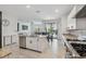 Kitchen island with stainless appliances overlooking open-plan living area at 11105 Balfour E St, Venice, FL 34293